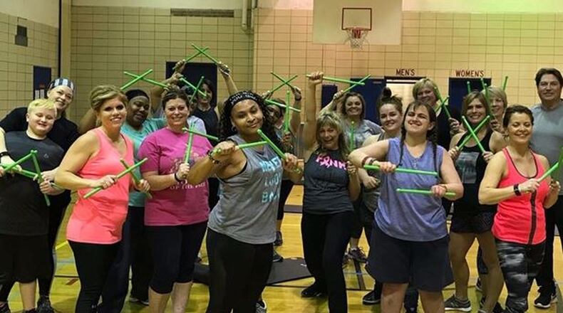 Brandi Collins with participants in a Pound fitness class. CONTRIBUTED