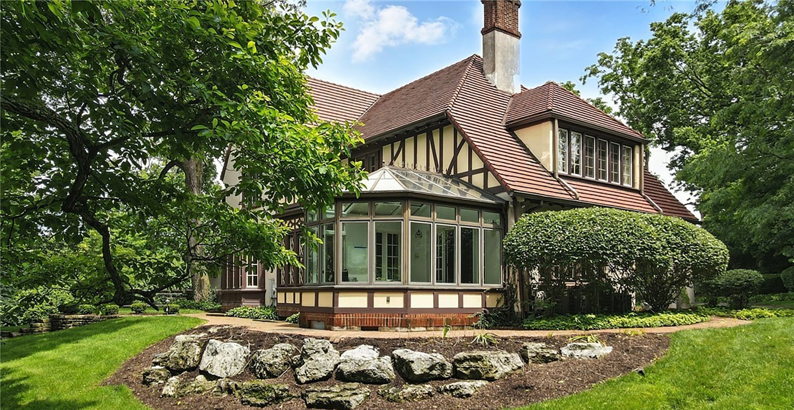 The rear and side of the home has a brick paver walkway and features a solarium/screened in porch.