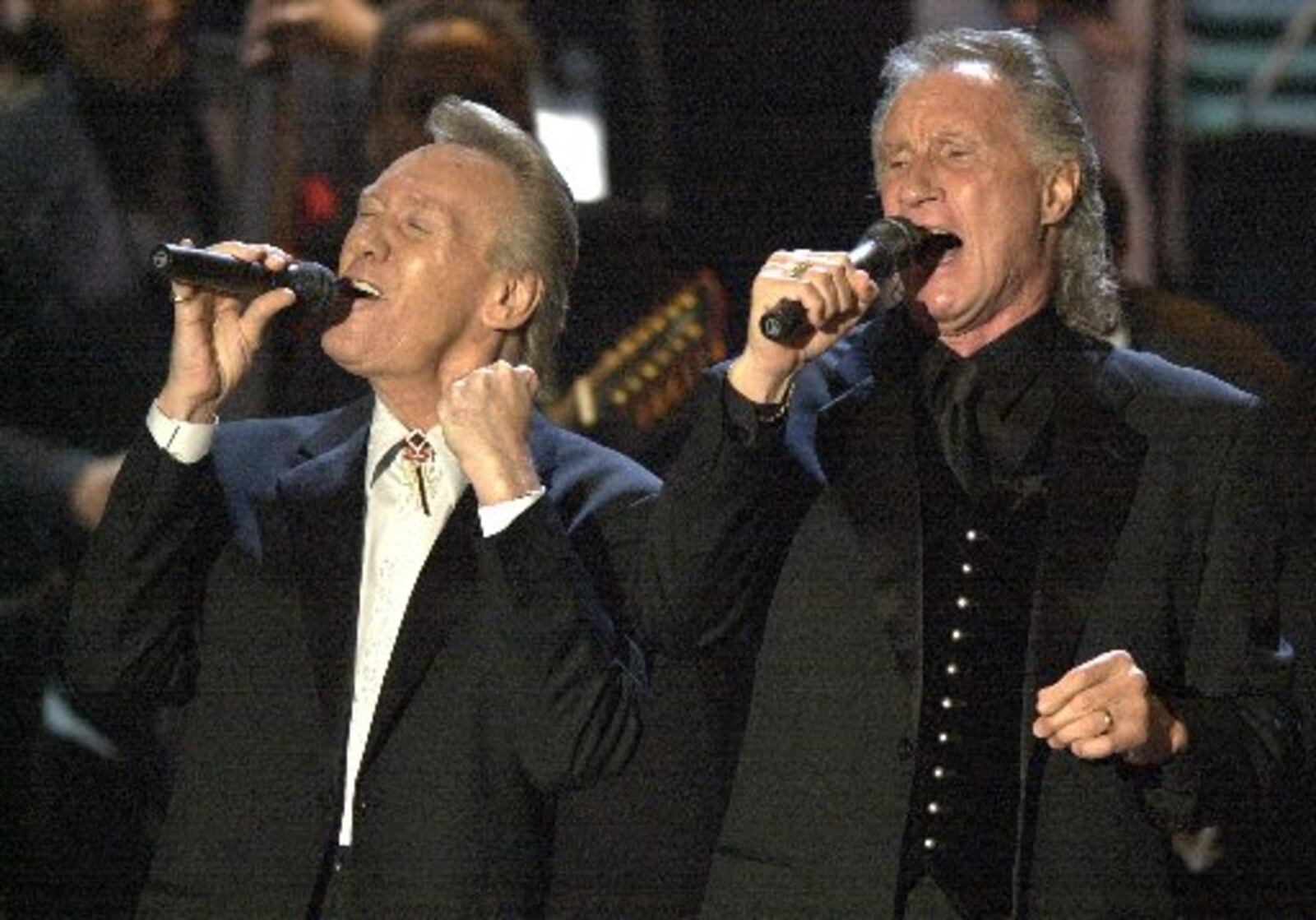 The Righteous Brothers, Bobby Hatfield, left, and Bill Medley perform before being inducted into the Rock and Roll Hall of Fame during the 18th Annual induction ceremony  in 2003, at New York's Waldorf Astoria. (AP Photo/Gregory Bull)