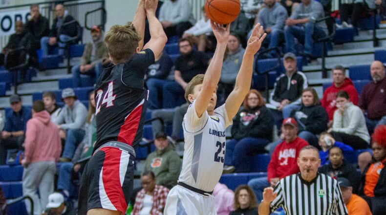 Oakwood's Will Maxwell shoots over Preble Shawnee's Mason Shrout during Sunday's Flyin' To The Hoop at Trent Arena. Maxwell scored 29 points to lead Oakwood to a 53-51 victory. Shrout scored 23. CONTRIBUTED/Jeff Gilbert