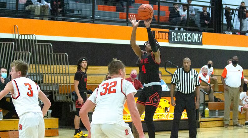 Wayne's Prophet Johnson shoots over the Beavercreek defense in Friday night's 63-53 victory at Beavercreek. Johnson led the Warriors with 23 points. Jeff Gilbert/CONTRIBUTED