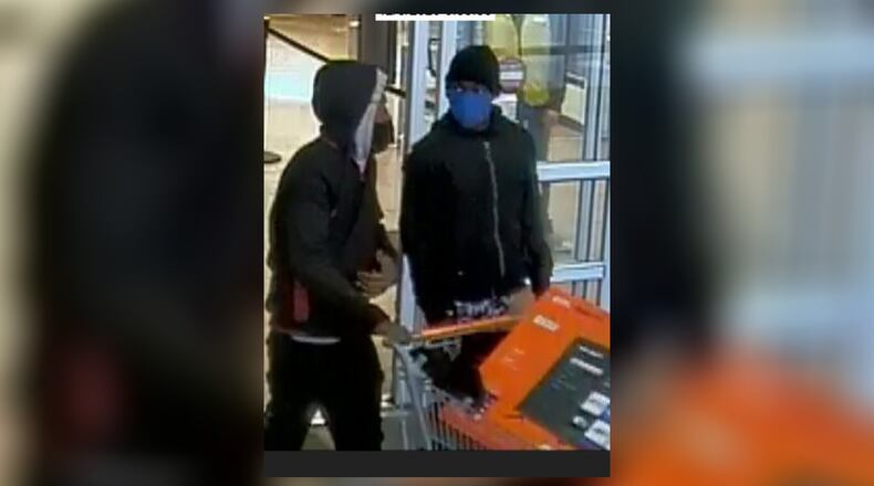 Dayton police are asking for the public's help identifying two suspects accused of using a credit card stolen from a vehicle in Dayton. Photo courtesy Dayton Police Department