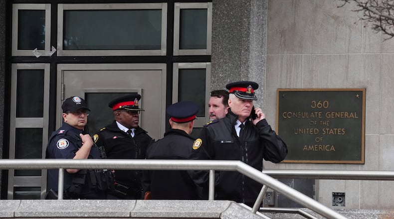 Toronto police officers investigate outside the U.S. consulate in Toronto on Tuesday March 10, 2026. (Frank Gunn/The Canadian Press via AP)