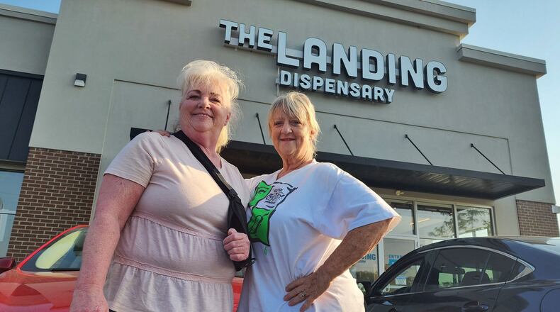 Becky Vliege, left, and Carey Farmer, from Liberty Twp. sat in their car as the first to arrive at The Landing Dispensary in Monroe on Tuesday, Aug. 6, 2024. NICK GRAHAM / STAFF