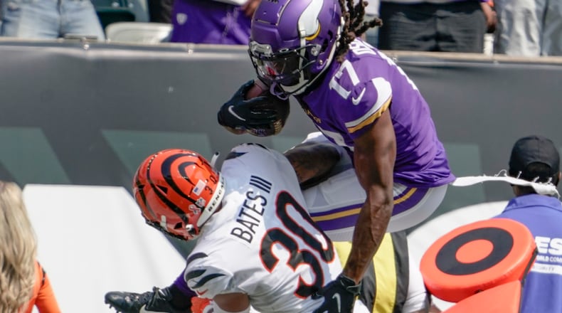 Minnesota Vikings wide receiver K.J. Osborn (17) tries to go over Cincinnati Bengals free safety Jessie Bates (30) as he runs after making a catch in the first half of an NFL football game, Sunday, Sept. 12, 2021, in Cincinnati. (AP Photo/Jeff Dean)