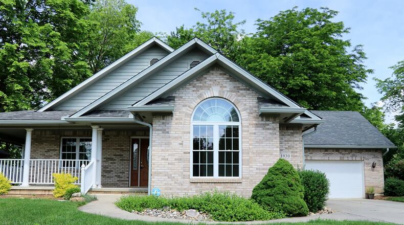 A front porch wraps around to the side of this ranch and is accessible from the formal front entry and through a set of French doors from the living room. The home has about 2,800 sq. ft. of living space with a finished, walk-out lower level. CONTRIBUTED PHOTOS BY KATHY TYLER