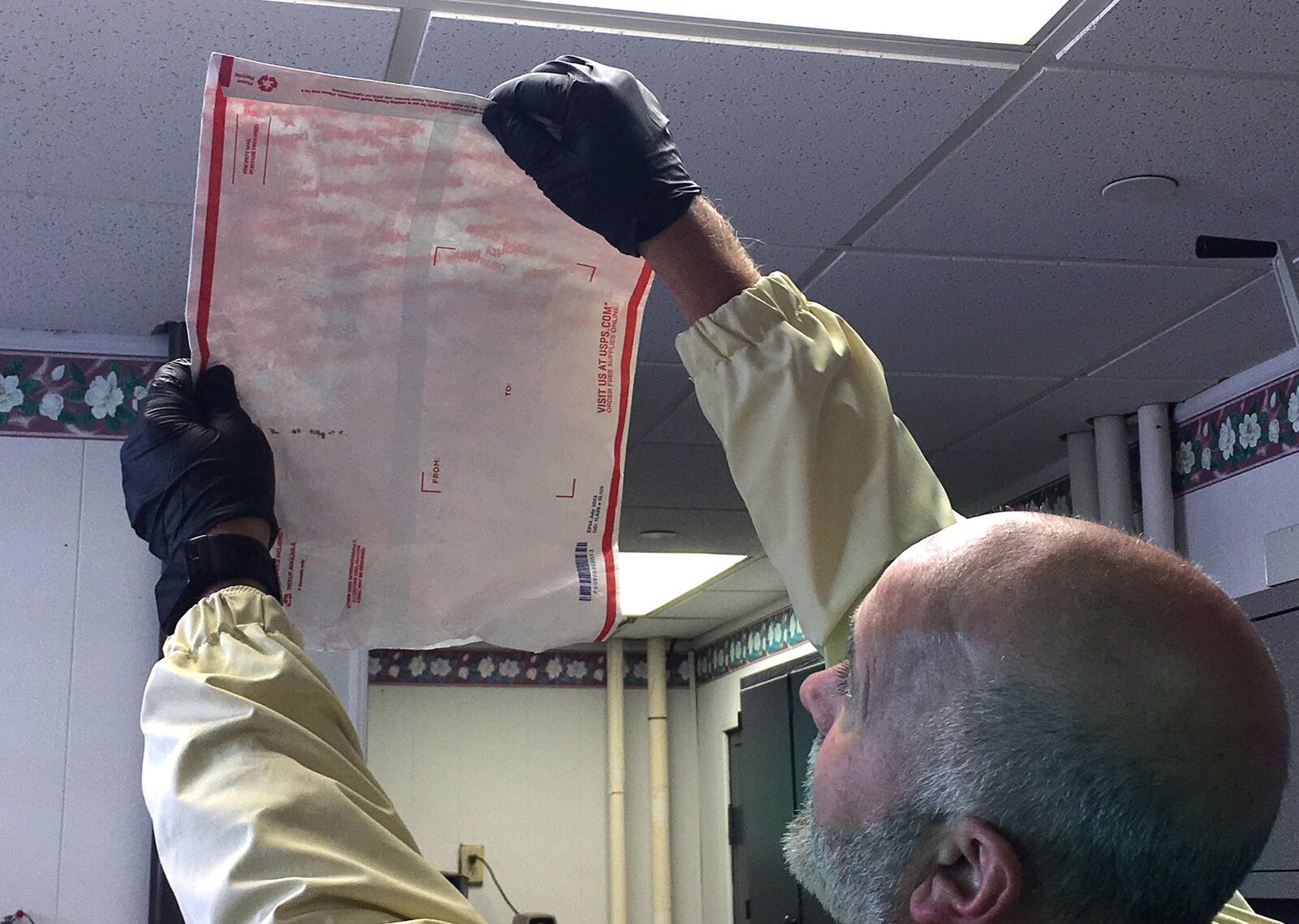 Major Kirk Keller hold up a envelope to the light that was sent to an inmate in the Greene County Jail, Friday, Nov. 17, 2017. It appears to have a strip of Suboxone, an opioid addiction treatment drug, hidden inside the seal, just next to his right thumb. KATIE WEDELL/STAFF