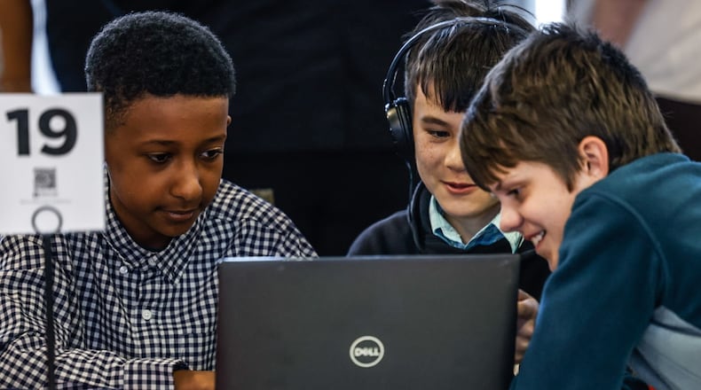 Dayton Stem School students from left, Noah Negassi, Jayden Clark and Liam Urbaniak play a game before the regional Flexfactor competition held at Sinclair College Friday April 19, 2024. The FlexFactor program is a collaborative technology and entrepreneurship program funded by the department of defense, that allows youth to discover the value of a career in advanced manufacturing. JIM NOELKER/STAFF