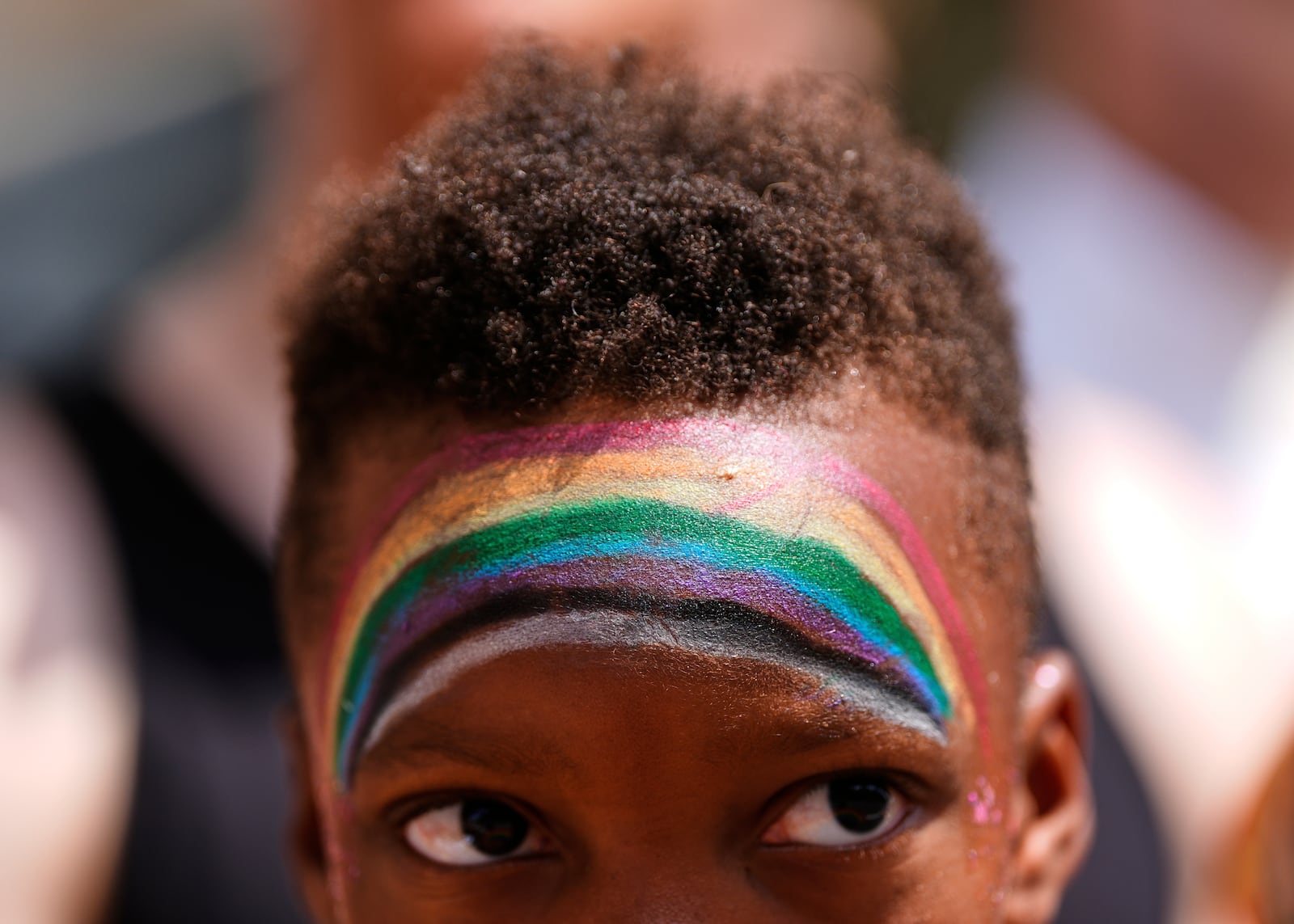 A child watches the World Pride parade, Saturday, June 7, 2025, in Washington. (AP Photo/Julia Demaree Nikhinson)