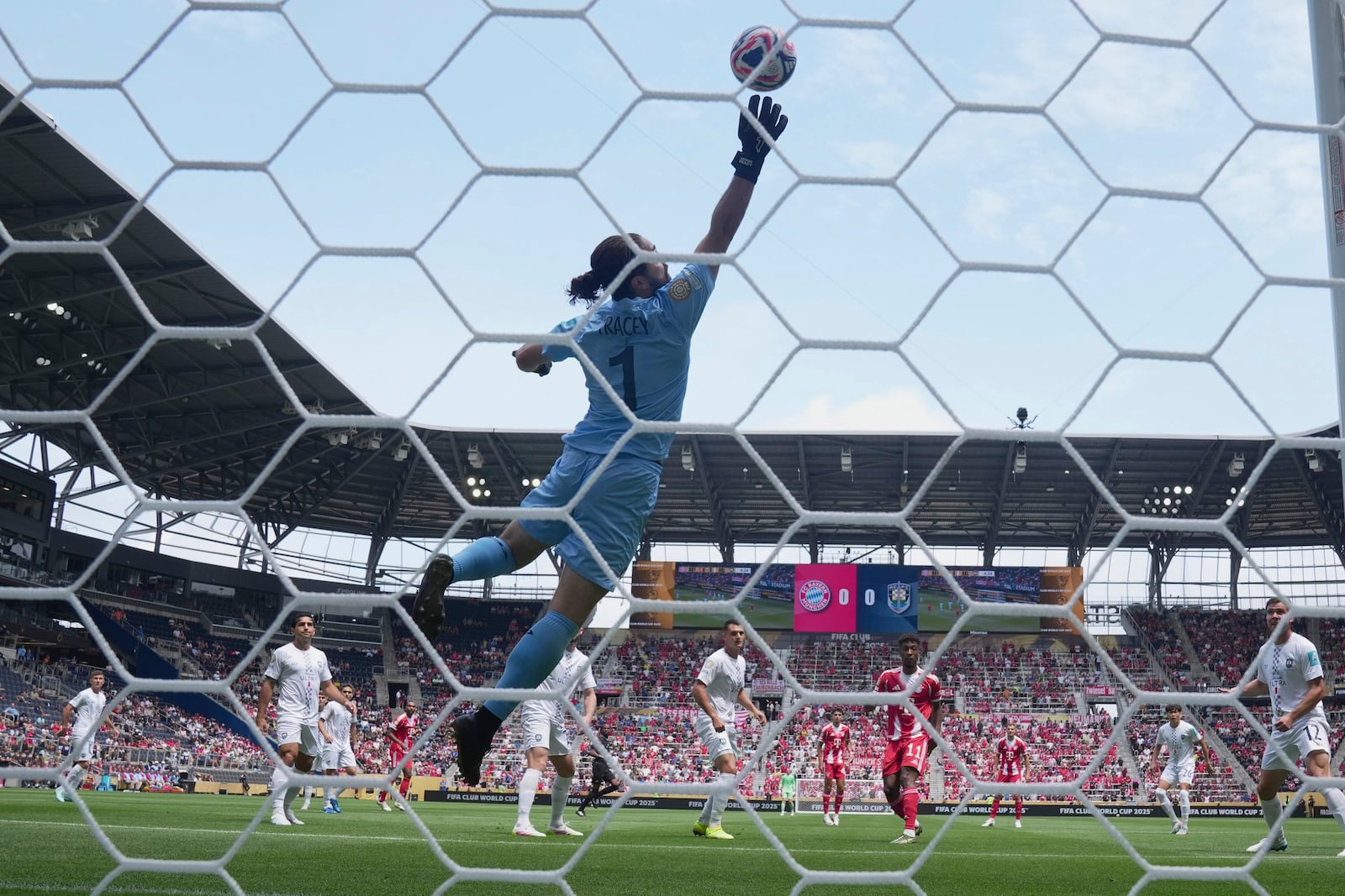 Bayern Munich's Kingsley Coman, center right, heads the ball past Auckland City's Conor Tracey to score the first goal during the Club World Cup group C soccer match between Bayern Munich and Auckland City in Cincinnati, Sunday, June 15, 2025. (AP Photo/Jeff Dean)