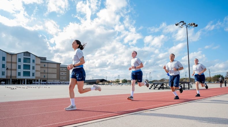 Trainee Anita Alvarez, 331st Training Squadron, leads from the front during the run portion of an official physical fitness test during week five of Basic Military Training at Joint Base San Antonio-Lackland, Texas on Dec. 23, 2024. (U.S. Air Force photo by Gregory Walker)