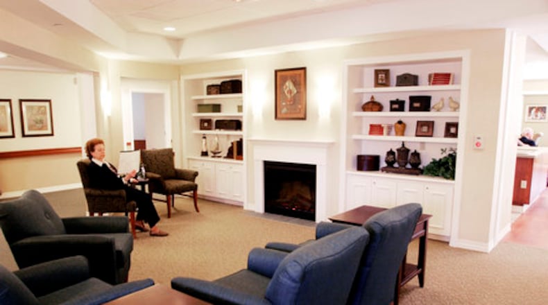 A Dayton Daily News file photo of a family room with a fireplace at Bethany Village's Memory Support Center in Centerville in April 2009. FILE