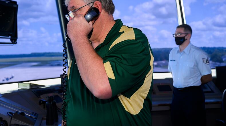 Lance Davis and Staff Sgt. Tyler Downhour of the 88th Operations Support Squadron work the air traffic control tower Aug. 2 at Wright-Patterson Air Force Base. On July 17, the pair responded to a C-5 Galaxy aircrew declaring an emergency when it appeared they would have to make a wheels-up landing. U.S. AIR FORCE PHOTO/R.J. ORIEZ