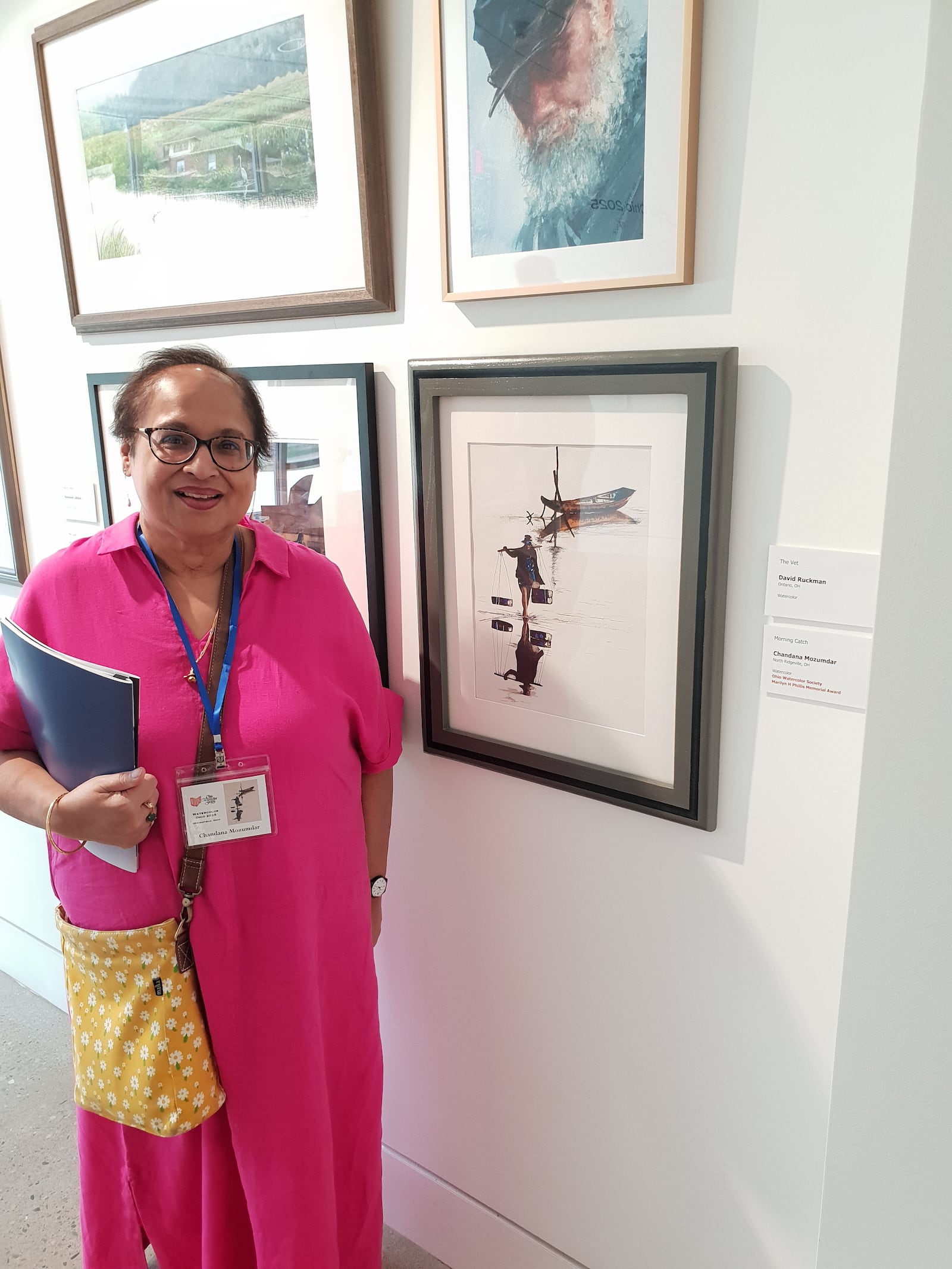 Former teacher Chandana Mozumdar stands next to her award-winning portrait of a fisherman following the opening of a new watercolor exhibition at the Springfield Museum of Art. CONTRIBUTED
