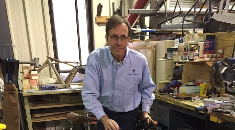 Jay Kinsigner, professor of Mechanical and Biomedical Engineering, shows off the finished e-bike created by students as collaborative capstone project. CONTRIBUTED
