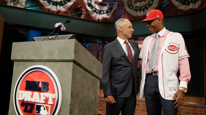 Hunter Greene, right, a pitcher and shortstop from Notre Dame High School in Sherman Oaks, Calif., talks to commissioner Rob Manfred after being selected No. 2 by the Cincinnati Reds in the first round of the Major League Baseball draft, Monday, June 12, 2017, in Secaucus, N.J.(AP Photo/Julio Cortez)