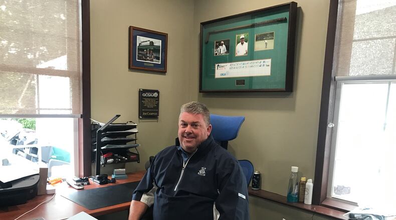 Jim Campion, the Director of Golf Courses and Grounds at NCR’s twin courses, in his office. The replica scorecard of Arnold Palmer’s final two competitive rounds, played a the 2005 Senior Open Championship at NCR South, hang on the wall behind him. Tom Archdeacon/STAFF