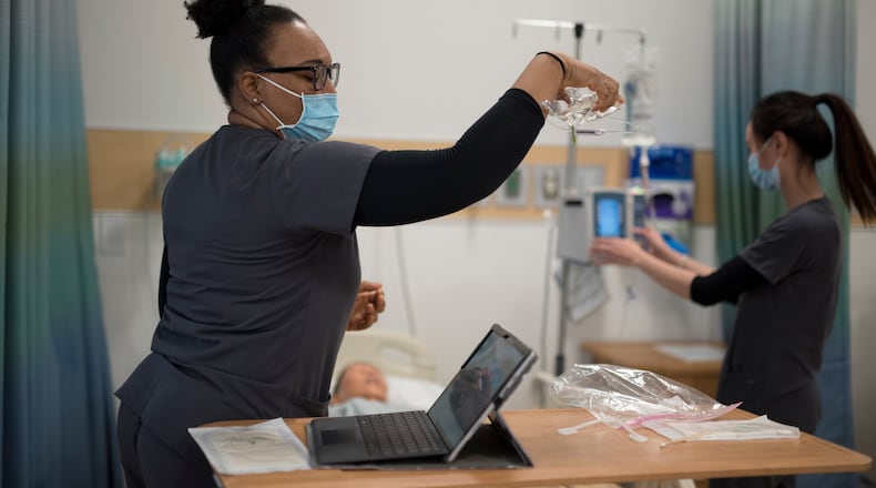 Sinclair nursing students work in a classroom setting. Sinclair is adding 18 new spots per year to its program. Courtesy of Sinclair Community College.