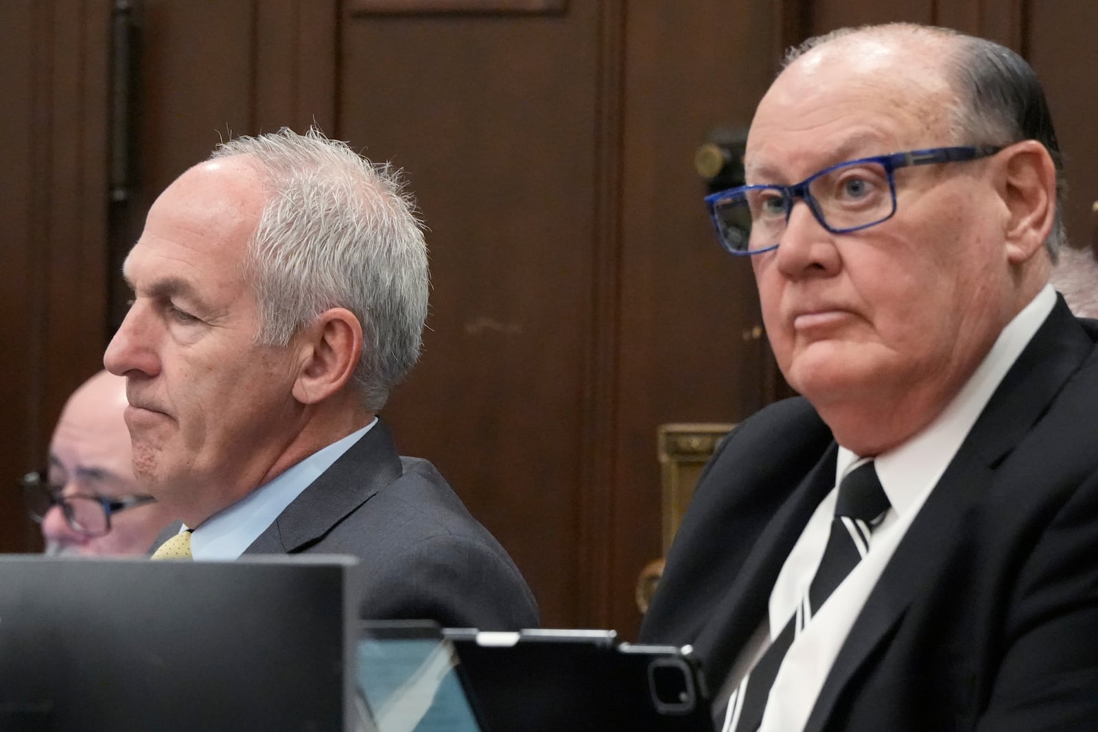 Ex-FirstEnergy Senior Vice President Michael Dowling, left, and former FirstEnergy CEO Chuck Jones listen during the cross examination of former FirstEnergy Chief Ethics Officer Ebony Yeboah-Amankwah in Summit County Court of Common Pleas Judge Susan Baker Ross's courtroom, in Akron, Ohio, Tuesday, Feb. 17, 2026. (Mike Cardew/Akron Beacon Journal via AP, Pool)