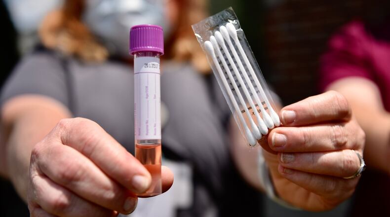 Medical assistant Carrie Bowman with Centerpoint Health on Breiel Boulevard in Middletown, shows a COVID-19 test kit outside the office Tuesday, June 16, 2020. Centerpoint Health will be on location at Robert “Sonny” Hill Community Center at 800 Lafayette Ave. in Middletown for testing today, June 17, 2020. NICK GRAHAM/STAFF