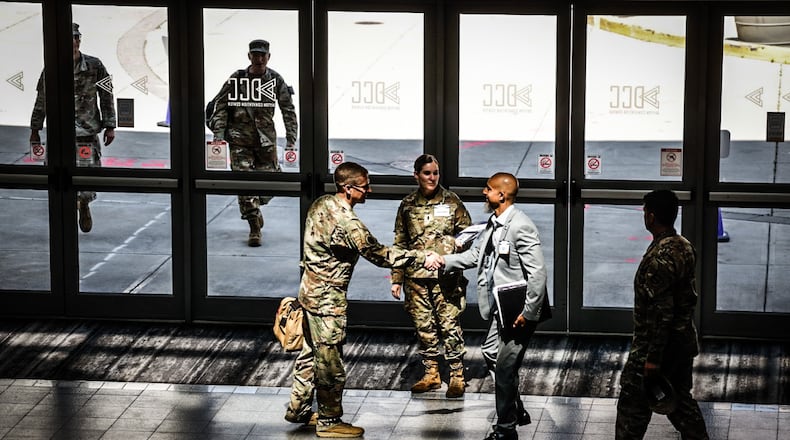 Airmen meet and greet people from the defense industry who are attending the Life Cycle Industry Days at the Dayton Convention Center.
