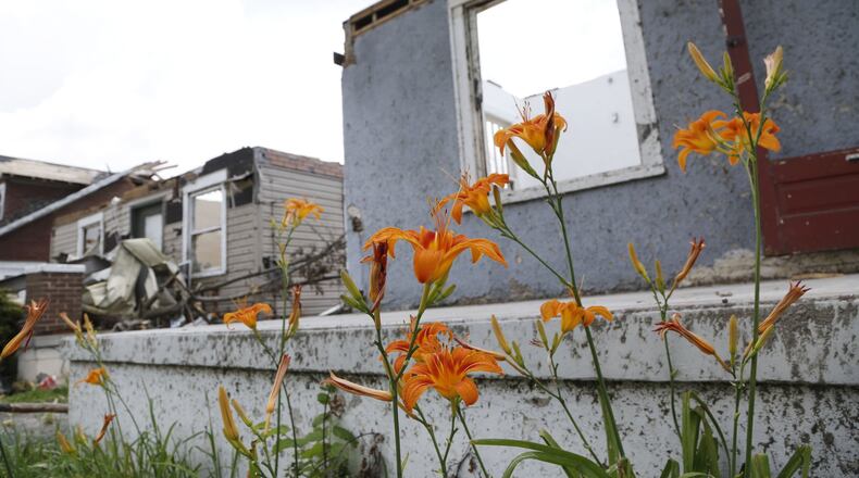 A row of tornado damaged homes on Troy Street from Oberer Drive past Kelly Avenue will most likely be demolished. Repairs are underway or waiting for insurance settlements in communities throughout the Dayton area one month after the Memorial Day tornadoes tore through many neighborhoods. TY GREENLEES / STAFF