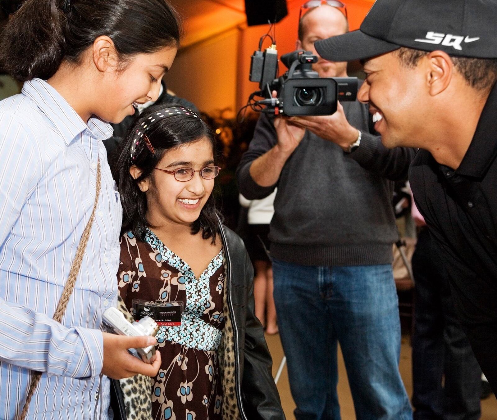 Ten years ago, when Trisha was 8, she met Tiger Woods for the first time at a golf course in North Carolina. Her sister Esha (left) looks on. CONTRIBUTED