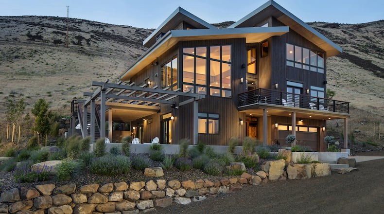 “The exterior design and materials were chosen to have the building appear as a basalt rock outcrop, which are extensive throughout the Yakima Canyon,” says homeowner Mark Kane. “Vertical cedar siding, pretty much all natural stone, granite stairs, Glulam beams, fir trim.” (Steve Ringman/Seattle Times/TNS)