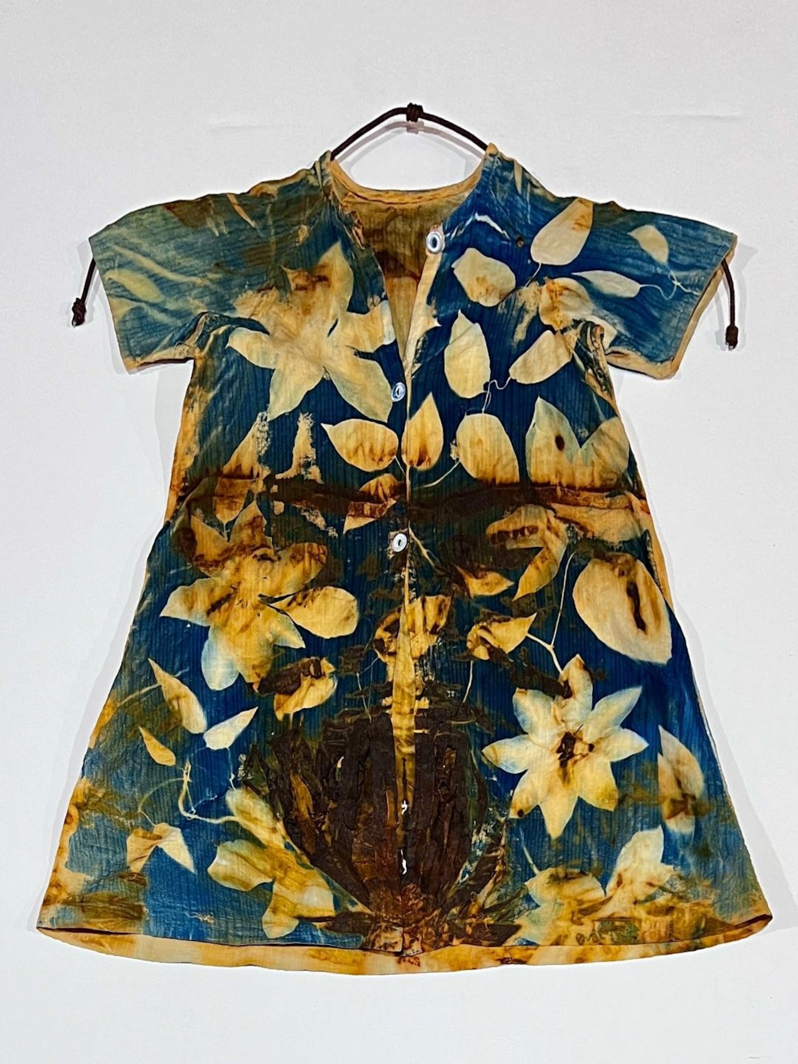 "Sister Artifice" by Suzi Hyden. Throughout Hyden's work she uses the eco-friendly cyanotype process on rust-dyed, repurposed vintage clothing, combined with symbolic botanical imagery, to create deeply personal and evocative works. CONTRIBUTED