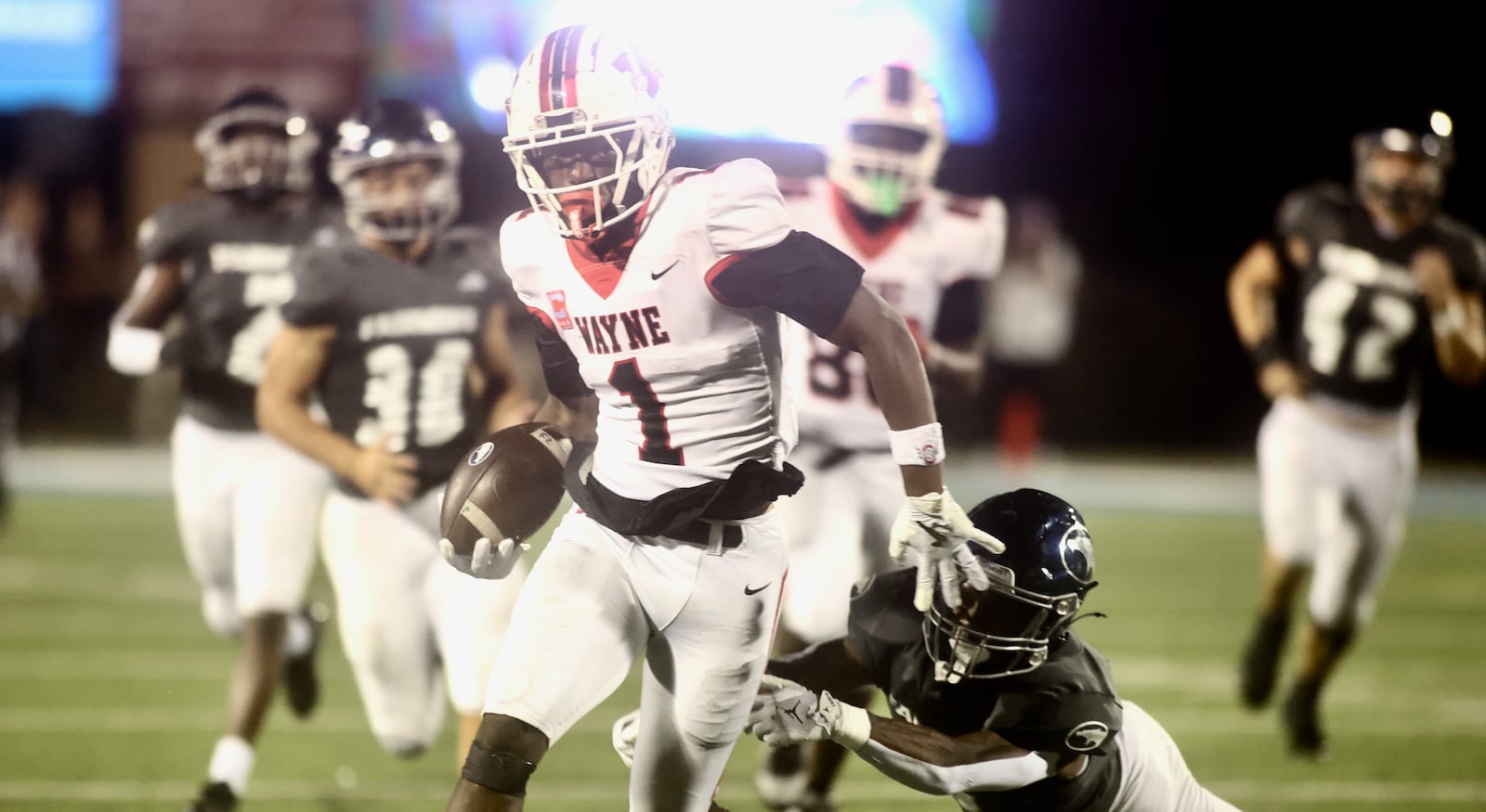 Wayne's Jamier Averette-Brown returns a kickoff against Fairmont on Friday, Sept. 19, 2025, at Roush Stadium in Kettering. David Jablonski/Staff