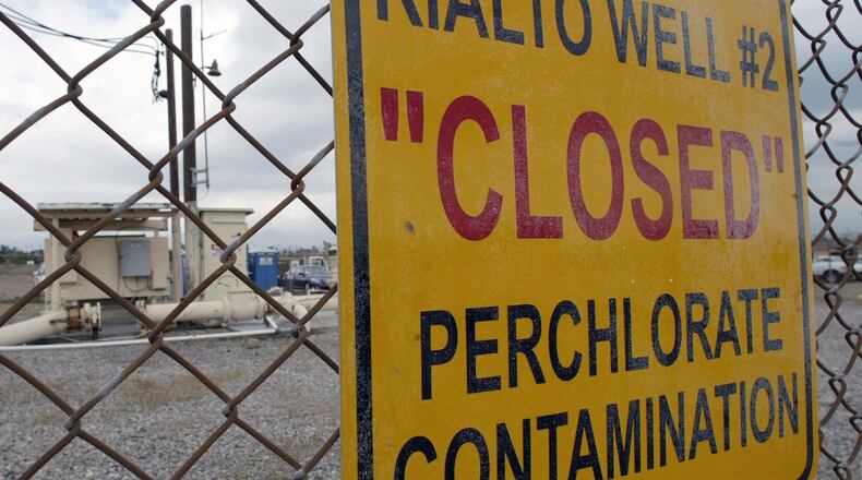 FILE - A sign is posted outside a water well indicates perchlorate contamination at a site in Rialto, Calif., March 28, 2005. (AP Photo/Ric Francis, File)