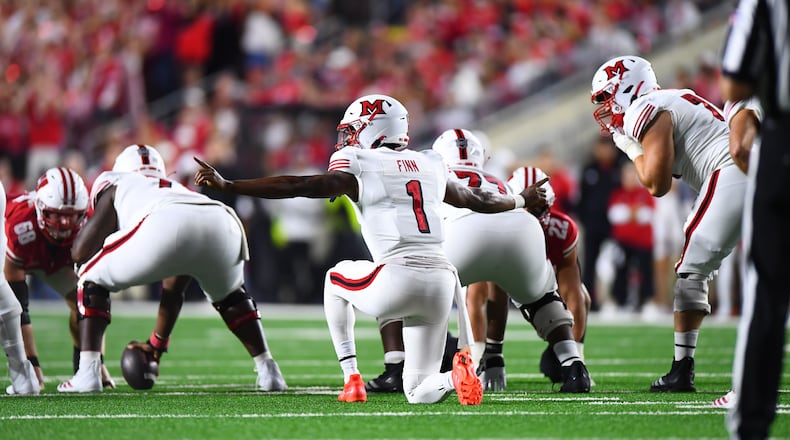 Miami quarterback Dequan Finn signals to his offense against Wisconsin on Thursday, Aug. 28 at Camp Randall Stadium in Madison, Wisc. KYLE HENDRIX / CONTRIBUTED