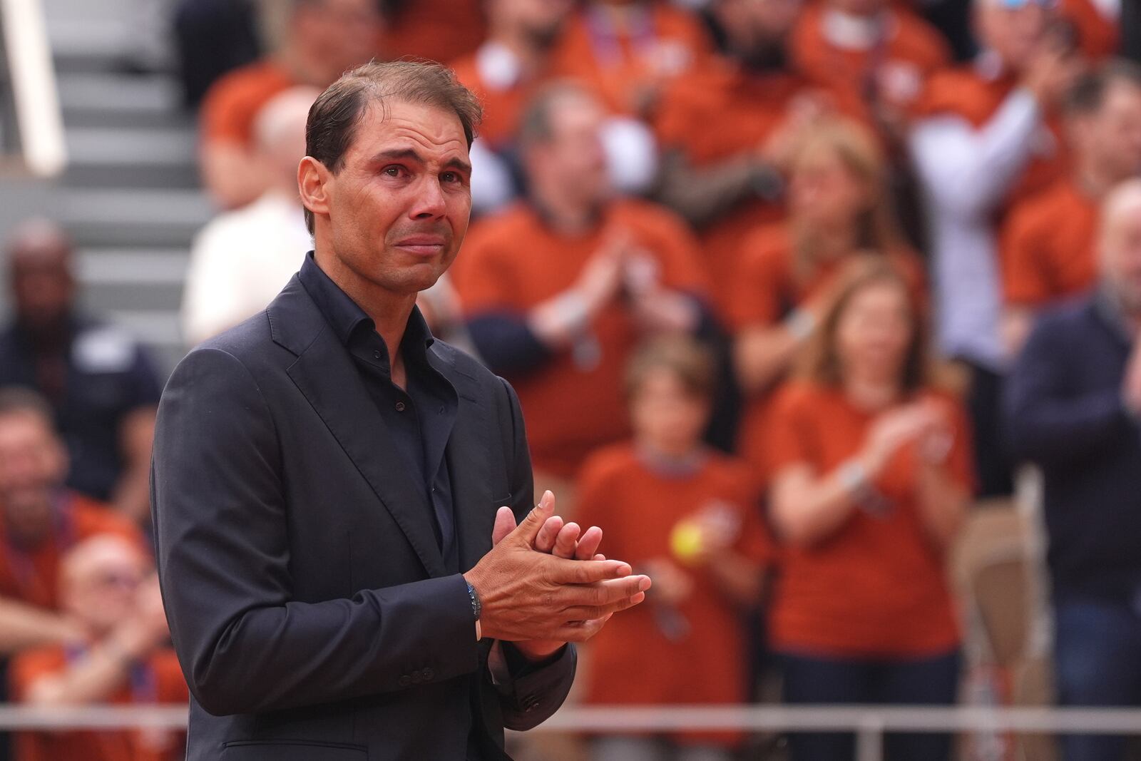 Rafa Nadal gets emotional during a farewell ceremony at center court Philippe-Chatrier, at the Roland-Garros stadium, in Paris, Sunday May 25, 2025. (AP Photo/Lindsey Wasson)