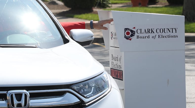 A voter places his ballot in the drop off box in front of the Clark County Board of Elections Tuesday. BILL LACKEY/STAFF