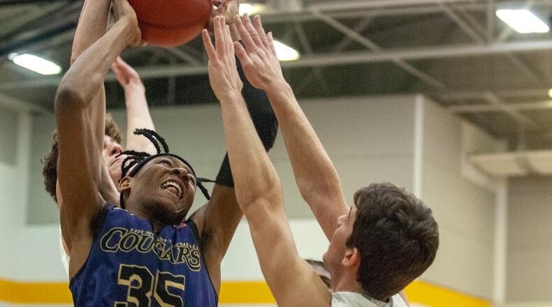 Thurgood Marshall’s Prophet Johnson tries to score against Chaminade Julienne during Saturday night’s sectional final at Springfield High School. Johnson scored 12 points and the Cougars advanced to a district final with a 57-35 victory. Jeff Gilbert/CONTRIBUTED