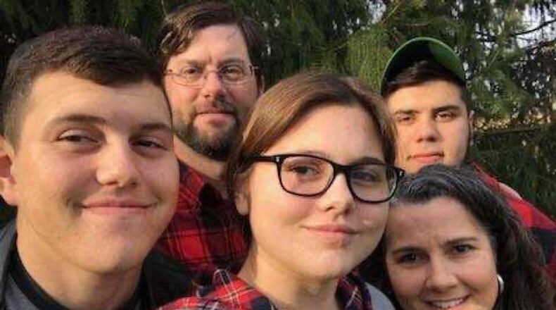 Kevin Behr, in back, with his wife, Kathy, and their three children.