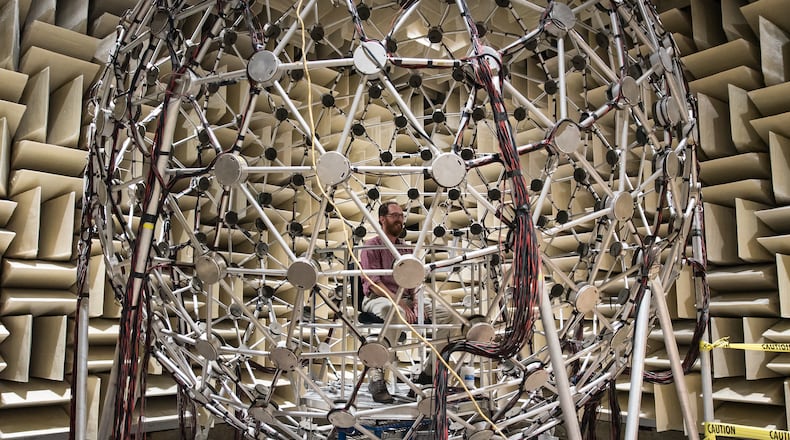 Dr. Eric Thompson, a research engineer with the Warfighter Interface Division, Battlespace Acoustics Branch, part of the 711th Human Performance Wing at Wright Patterson Air Force Base, sits inside their Auditory Localization Facility (ALF). The facility allows researchers to test 3-D audio software that spatially separates sound cues to mimic real-life human audio capabilities. The application allows operators in complex communication environments with multiple talking voices to significantly improve voice intelligibility and communication effectiveness. (U.S. Air Force photo by Richard Eldridge)