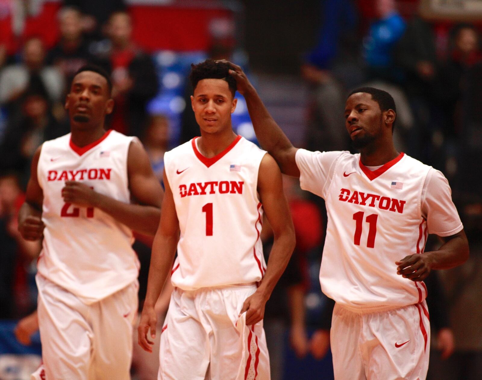Dayton guard Scoochie Smith, right, celebrates a basket with Darrell Davis, center, and Dyshawn Pierre during a game against Davidson on Tuesday, Jan. 12, 2016, at UD Arena in Dayton. David Jablonski/Staff