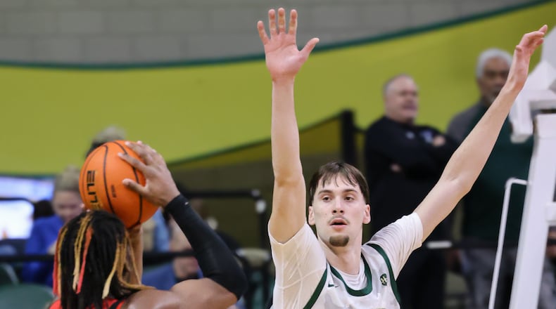Wright State freshman forward Kellen Pickett tries to block a shot by Youngstown State's Bryson Dawkins during a Horizon League game on Thursday, Jan. 15 at Ervin J. Nutter Center in Fairborn. BRYANT BILLING/STAFF