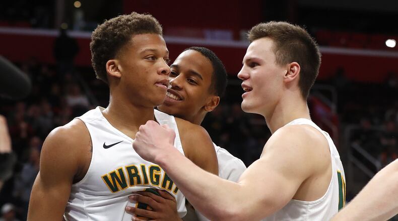 Wright State’s Everett Winchester, left, celebrates a basket with Jaylon Hall and Grant Benzinger during the second half of the team’s NCAA college basketball game against Cleveland State for the championship in the Horizon League men’s tournament in Detroit, Tuesday, March 6, 2018. (AP Photo/Paul Sancya)