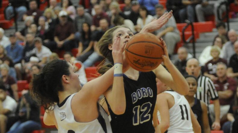 Springboro’s Haylie Crouch (with ball) is confronted by Lebanon’s Rachel Perry during a Division I sectional final at Troy on Feb. 24, 2017. MARC PENDLETON/STAFF