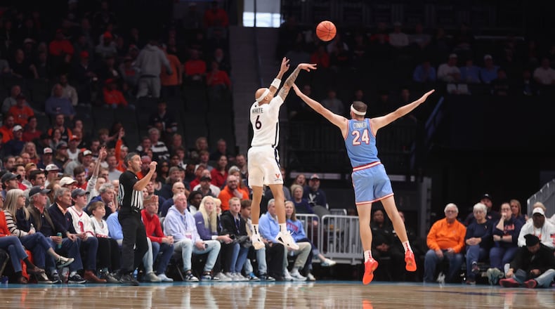 Virginia's Jacari White makes a 3-pointer against Dayton in the second half on Saturday, Dec. 6, 2025, at the Spectrum Center in Charlotte, N.C. David Jablonski/Staff