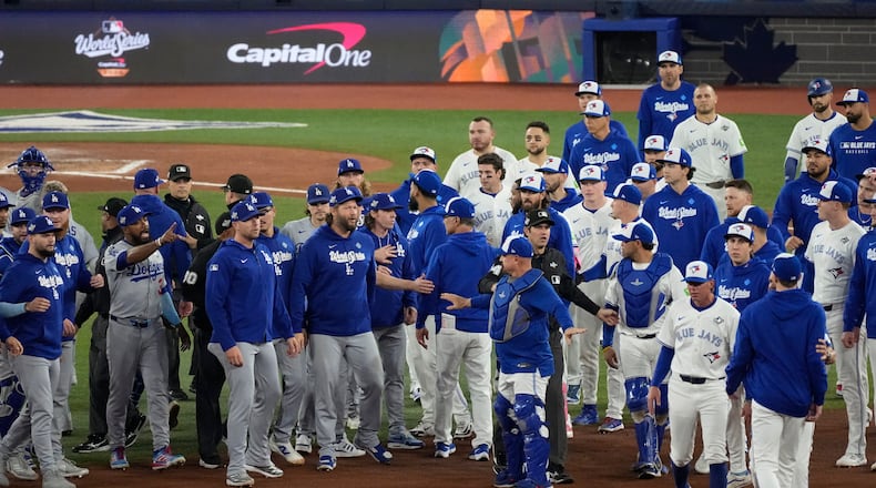The Los Angeles Dodgers and the Toronto Blue Jays benches clear after Blue Jays' Andrés Giménez was hit by a pitch during the fourth inning in Game 7 of baseball's World Series, Saturday, Nov. 1, 2025, in Toronto. (AP Photo/Ashley Landis)