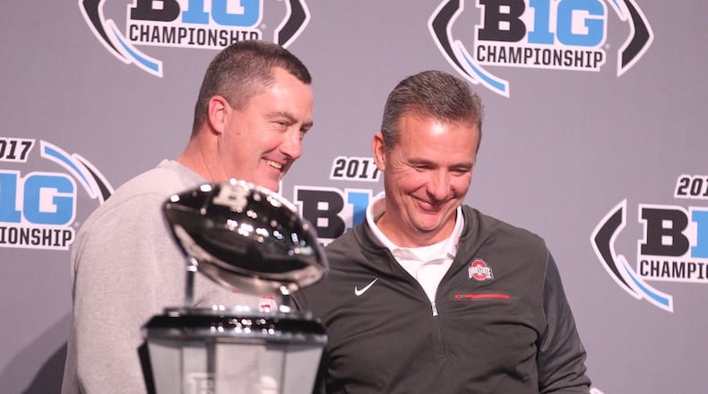 Wisconsin coach Paul Chryst and Ohio State coach Urban Meyer pose for a photo with the Big Ten Championship trophy on Friday, Dec. 1, 2017, at Lucas Oil Stadium in Indianapolis. David Jablonski/Staff