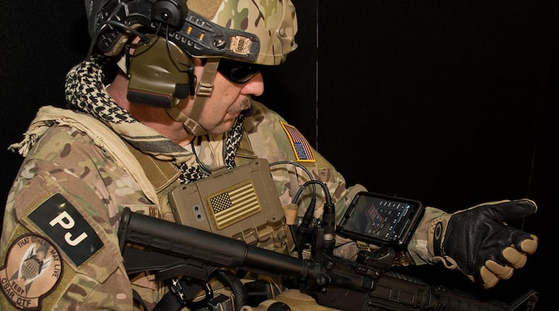 Chief Master Sgt. Robert Bean, an Air Force pararescue jumper, demonstrates how the Battlefield Assisted Trauma Distributed Observation Kit can be worn on the wrist, providing awareness of the health status of multiple patients. Developing BATDOK required Air Force medical researchers to embed with pararescue jumpers on live missions to ensure the tool met the rigorous standards required by combat Airmen. (Courtesy photo)