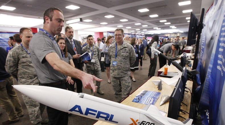 Barry Hellman, project manager for the Air Force Research Lab’s X-60A Hypersonic Research Vehicle, explains the details of the project to AFRL personnel who were a part of the AFRL Inspire Tech Expo at the Dayton Convention Center on Thursday. TY GREENLEES / STAFF