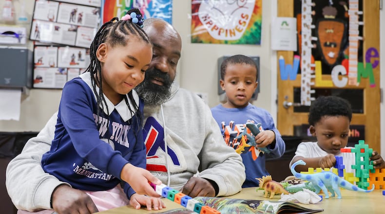Jovan Etter reads to children in his classroom at Miami Valley Child Development Center in Trotwood on Tuesday. A program that provides child care and early childhood education could see its funding eliminated if a Trump administration budget proposal moves forward. BRYANT BILLING / STAFF