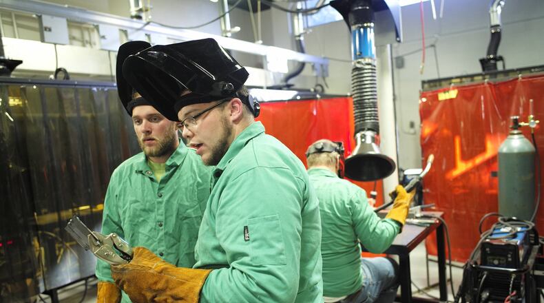 Eric Schellentrager and Cody Herron look over their welds in the Welding Lab. Bill Lackey/Staff