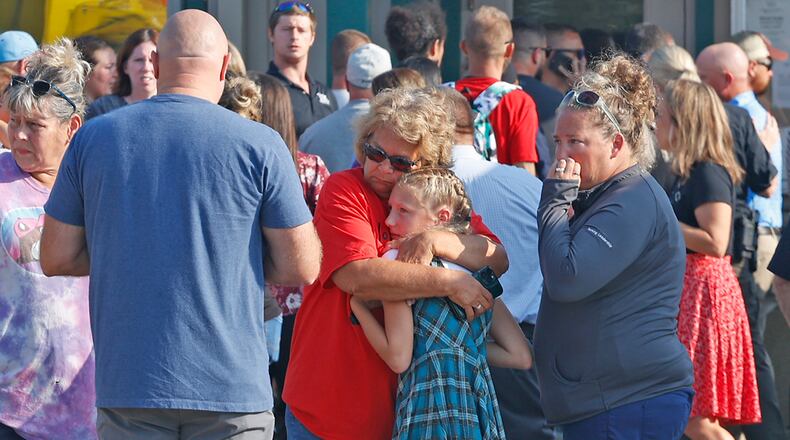 Family members are reunited with their children at the German Township Government Center following a Northwestern School District bus crash on State Route 41 in Springfield, Ohio, Tuesday, Aug. 22, 2023. (Bill Lackey/The Springfield News-Sun via AP)