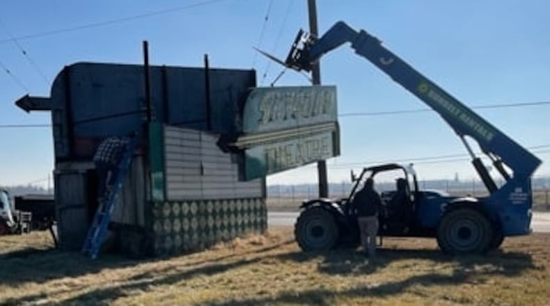 Crews work to remove the Skyborn Theater sign. Photo courtesy of the Fairborn Area Historical Society.